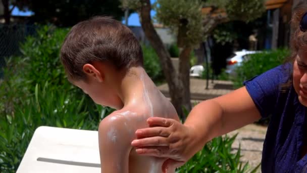 Little boy is smeared with sun protection cream — Αρχείο Βίντεο