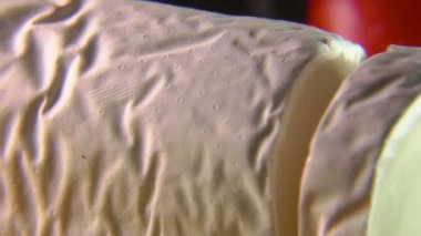 Super close up of a thick piece of Sainte maure de Touraine goat cheese