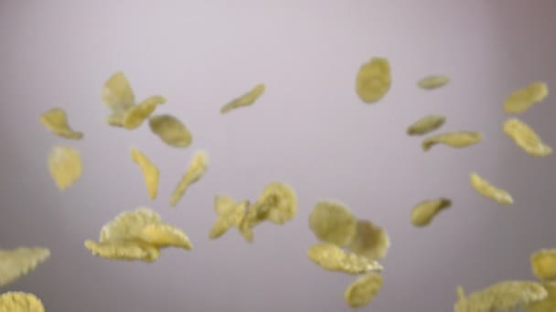 Cereal corn flakes are flying on the white background — Stock Video