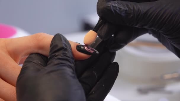 Close up of a manicurists hands coloring stylish manicured nails — 비디오