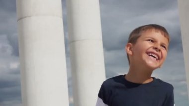 Happy boy jumping, dancing with a phone in his hands and laughing