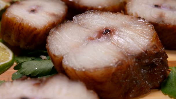 Close up of smoked eel pieces lying on a wooden bamboo board — Stock Video