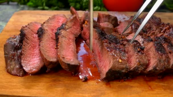 The chef turns the finished super juicy steak on a wooden board — Stock Video