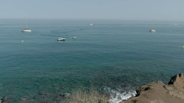 Aerial shooting of a yacht sailing out of the marina in the Mediterranean Sea — Stock Video