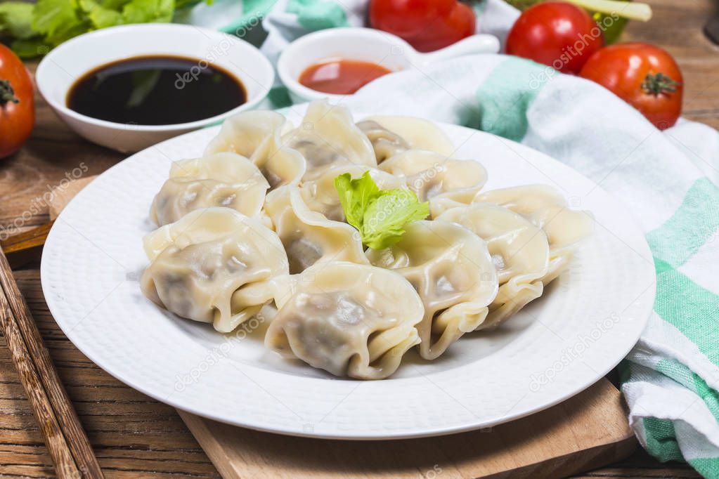 Asian dumplings in bowl, chopsticks, Chinese dumplings for dinner.Chinese dumplings for dinner/lunch. Traditional Asian/Chinese cuisine.