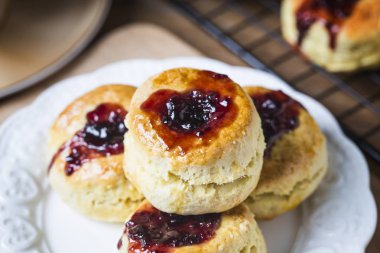 English scones with cream and strawberry jam clipart