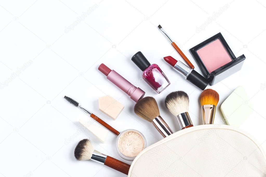 Cosmetic bag and makeup products on color background