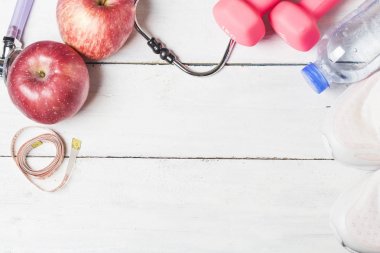 Sağlık stetoskop ve bir elma meyve ahşap arka plan üzerinde. H