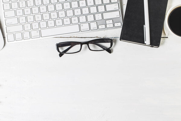 Blank paperwork template for designers. Responsive design mockup on vintage wooden background. Paper, letterhead, coffee cup, smartphone, pencil and headphones on wooden table background. Top view.