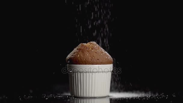 Muffin cake with powdered sugar on dark background with copyspace. Slow motion — Stock Video