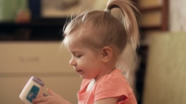 Little girl taking temperature using a digital thermometer indoors in 4k — Stock Video