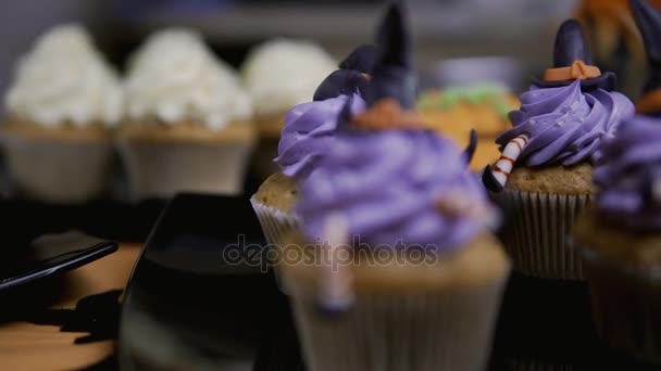Cupcakes a porcukrot a kalap és a lábak. Finom Muffin, mint a boszorkány. Halloween koncepció — Stock videók