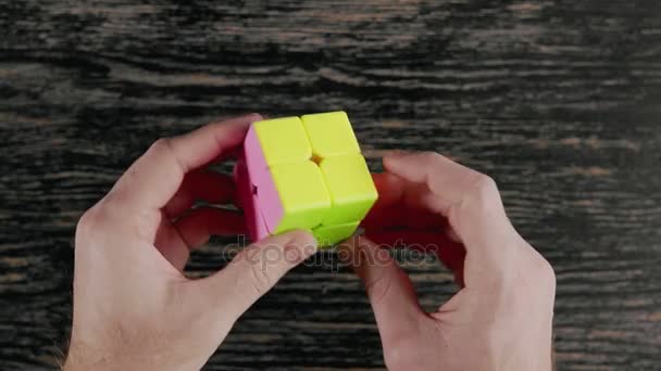 明斯克, 白俄罗斯-2017年11月20日: 男孩手解决 Rubiks 立方体。顶部视图 — 图库视频影像