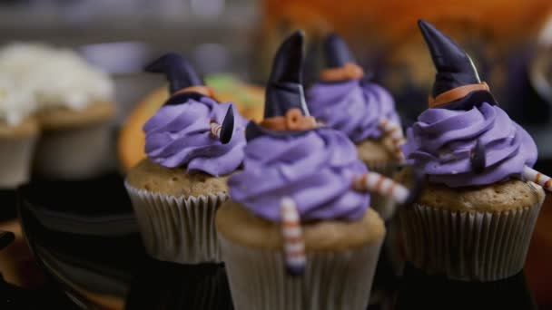 Cupcakes with icing hat and legs. Delicious Muffin like witch. Halloween concept — Stock Video