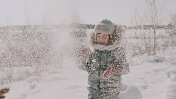 Madre jugando nieve con su hijita en cámara lenta — Vídeos de Stock