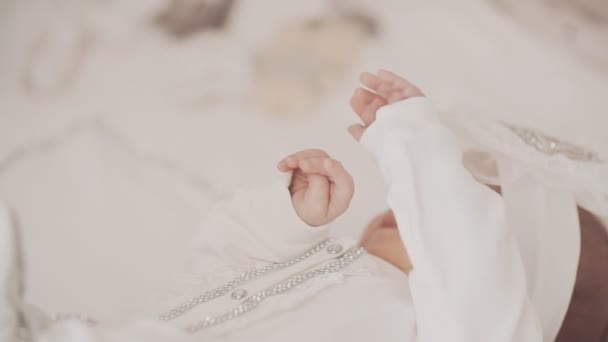 Bebê recém-nascido bonito em roupas brancas na cama — Vídeo de Stock