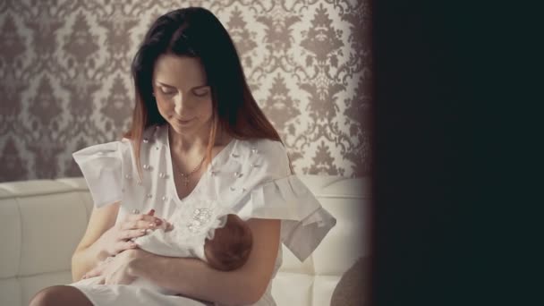 Young mother holds on hands cute little newborn baby . Close up shot indoors. — Stock Video