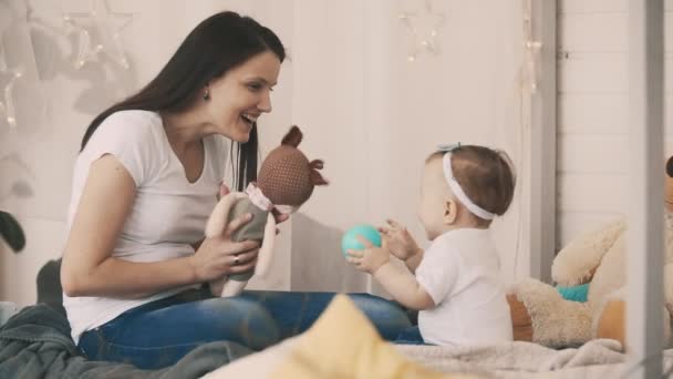 Jovem mãe e filha se divertindo no quarto com brinquedo em câmera lenta — Vídeo de Stock