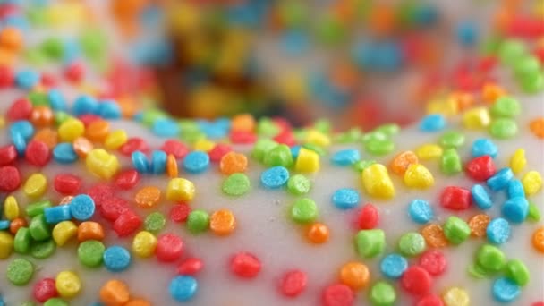 Delicious sprinkled sweet donut rotating. Colorful doughnut. Close-up in 4K, UHD — Stock Video