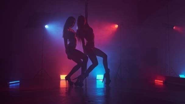 两个跳舞的人在黑暗的演播室里 两根杆子上都是蓝烟和红烟 美丽的舞女和性感的身体 全长4公里 Uhd — 图库视频影像