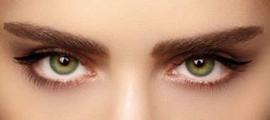 Perfect shape of eyebrows and extremly long eyelashes. Macro shot of fashion eyes visage. Before and after clipart