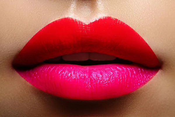 Cosméticos, maquillaje. Lápiz labial brillante en los labios. Primer plano de hermosa boca femenina con maquillaje labial rojo y rosa. Parte de la cara — Foto de Stock