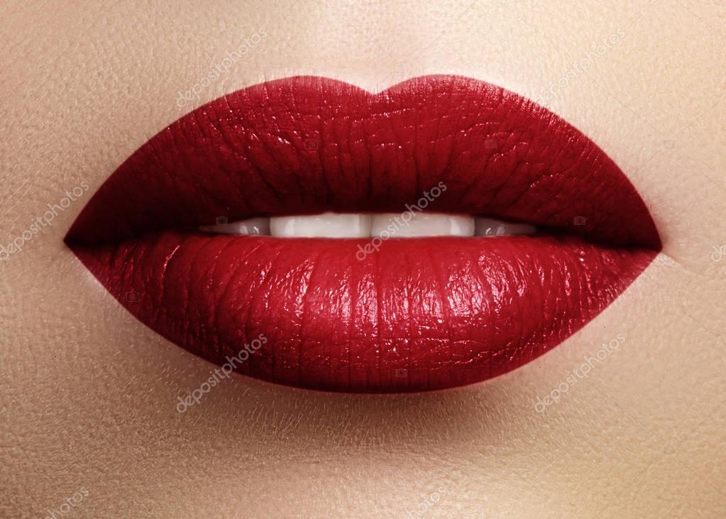 Cosmetics, makeup. Bright lipstick on lips. Closeup of beautiful female