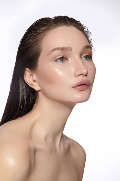 Beautiful Face of young Woman. Skincare, Wellness, Spa. Clean soft Skin, Fresh look. Natural daily makeup, wet hair