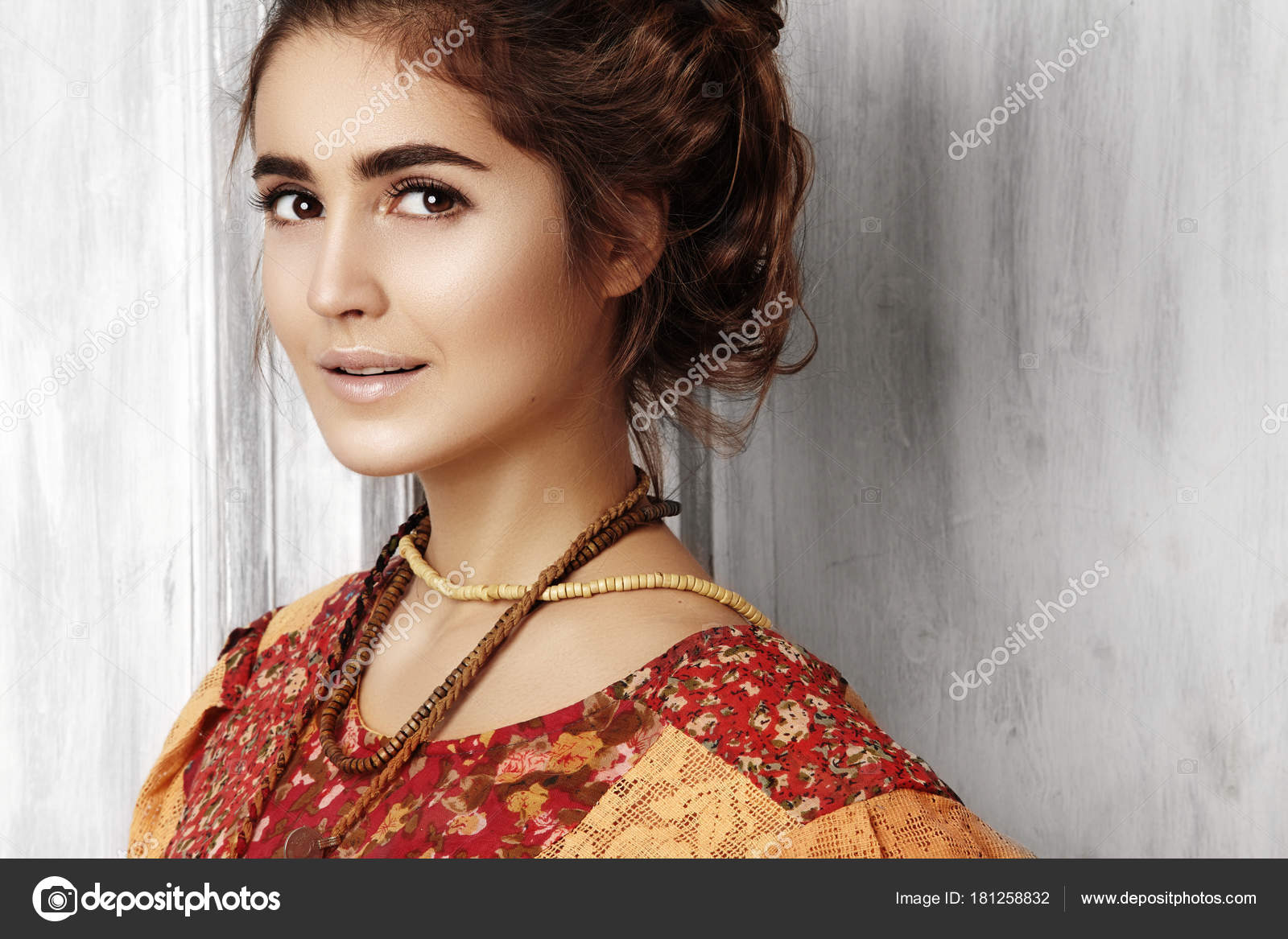 Beautiful young woman with long curly hairstyle, fashion jewelry with  brunette hair. Indian style clothes, long dress Stock Photo by  ©.com 181258832