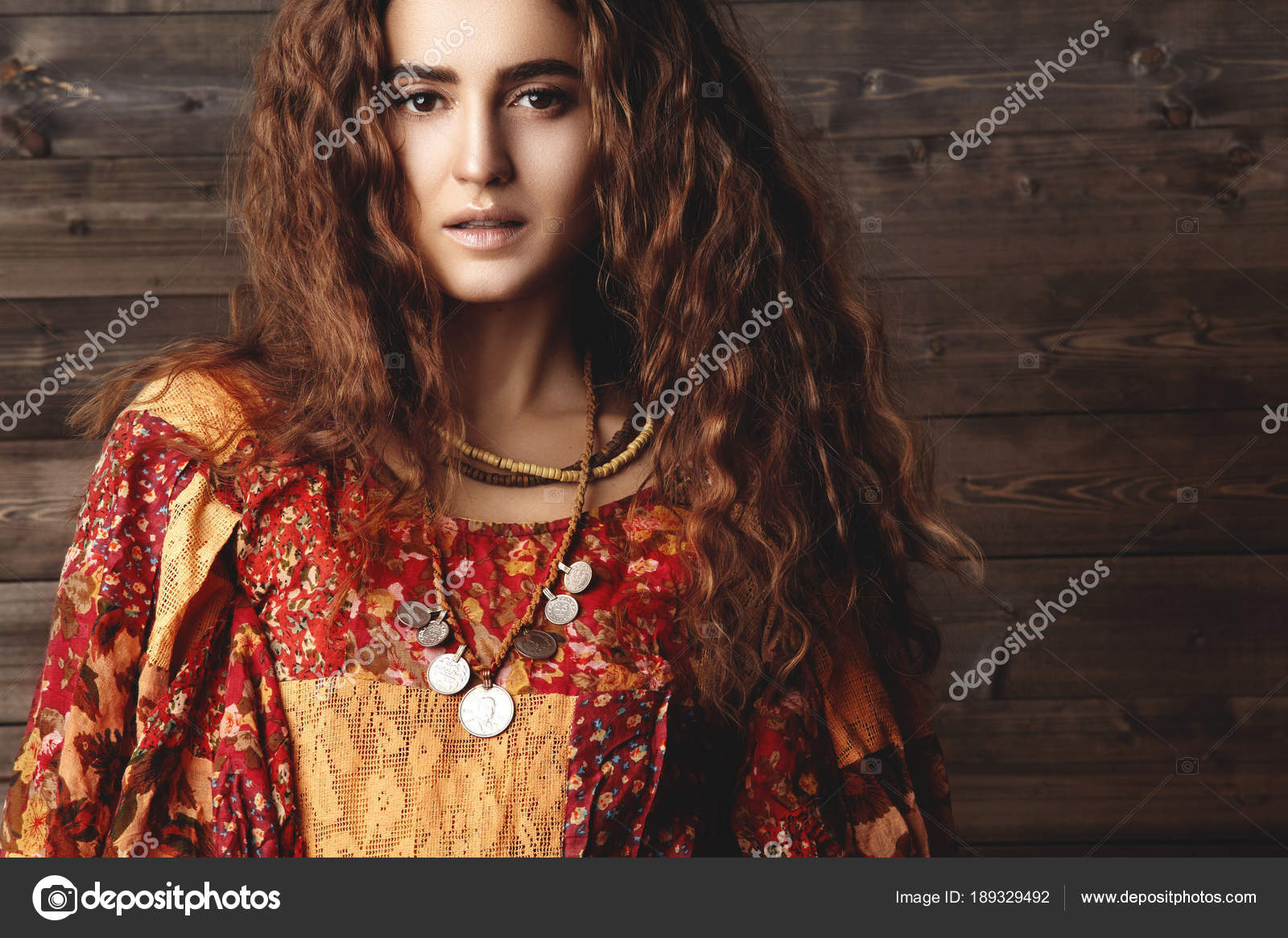 Beautiful young woman with long curly hairstyle, fashion jewelry with brunette hair. Indian style clothes, long dress Stock Photo by ©.com 189329492 Beautiful young woman with long curly hairstyle, fashion jewelry with brunette hair. Indian style clothes, long dress Stock Photo by ©.com 189329492