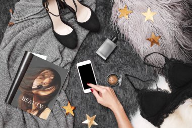 Moda geçmişinde Mobile kullanan Kadın Eller. Kadın Müşteri Alıştırma Uygulaması kullanıyor. Kadın aksesuarlarıyla Top View 'a yakın çekim. Hücre Teknolojisinde Çevrimiçi Ödemeleri Olan Moda Kıyafetler