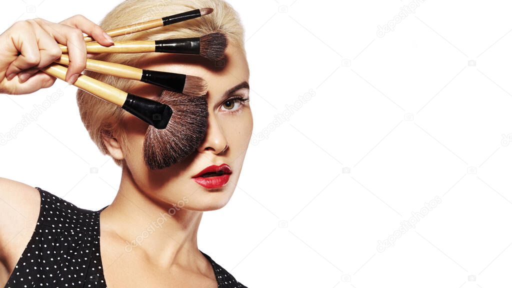 Beauty Treatment. Girl with Makeup Brushes. Fashion Make-up for Sexy Woman. Makeover. Make-up Artist Applying Visage on white background.