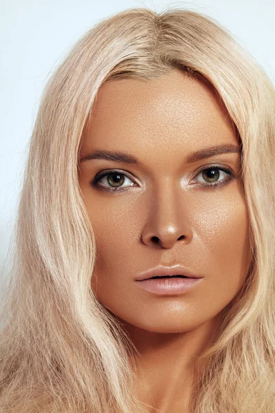 Beautiful close-up portrait of tanned skin woman. Sunburnt girl face with natural boho bronzed make-up. Sexy bohemian beach summer style makeup