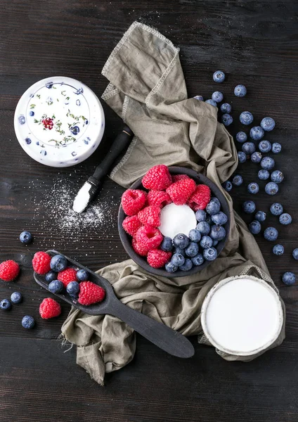 Blueberrys en raspberrys op rustieke houten bord — Stockfoto