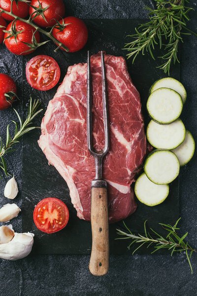 Raw steak with vegetables