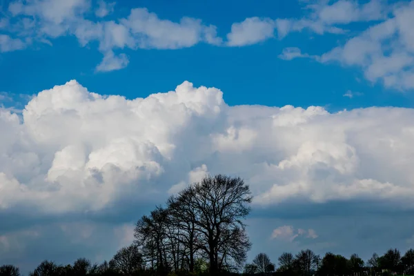 Schöner blauer Himmel mit Wolken und Sonnenstrahlen — Stockfoto