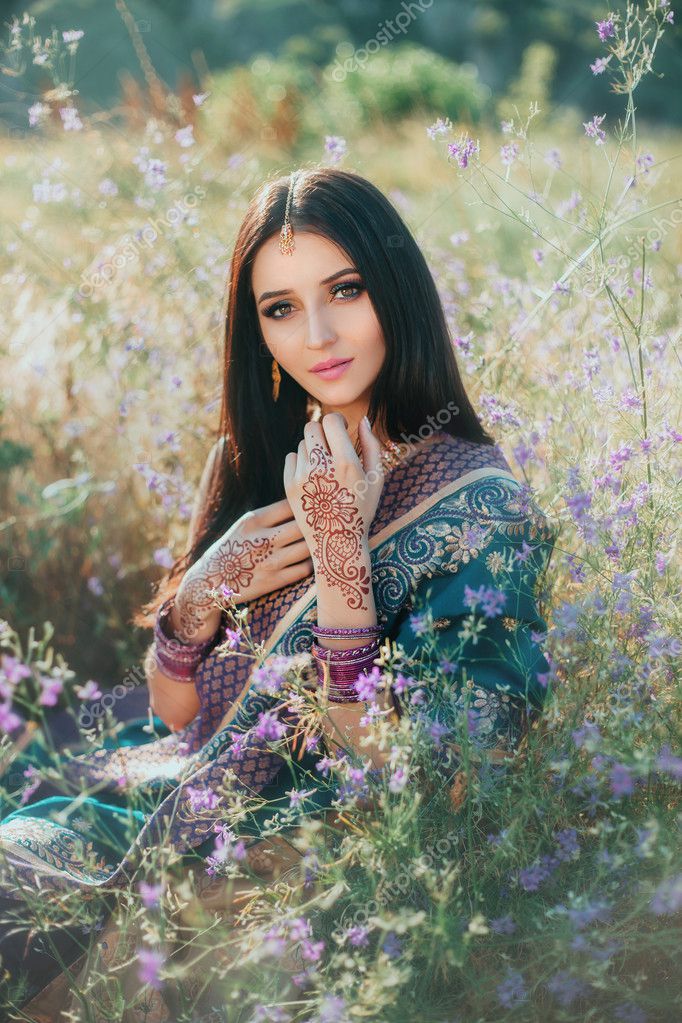 Luxurious Indian woman sitting in field flowers on natural. Stock Photo by © 126373662 Luxurious Indian woman sitting in field flowers on natural. Stock Photo by © 126373662