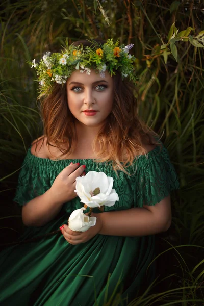 Luxuriöse Dame im langen grünen Kleid mit nackten Schultern — Stockfoto