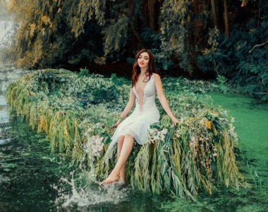 brunette girl in a white vintage dress with a deep neckline, sitting on a boat and playing bare feet in river water. Spray and drops. Cute face. Summer day. Wedding decorations with willow and flowers clipart