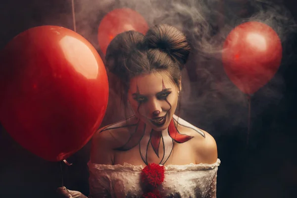 Creepy beautiful woman in image of a scary clown. Carnival outfit white dress — Stock Photo, Image