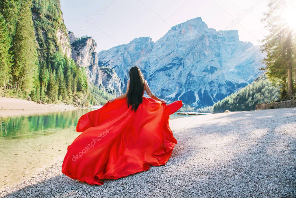  lady tourist hair run walk rear view. Art luxury long vintage red design dress satin silk train floating fly vawy wind.