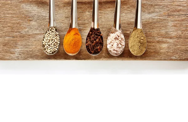 Spice and herbs in steel spoon — Stock Photo, Image