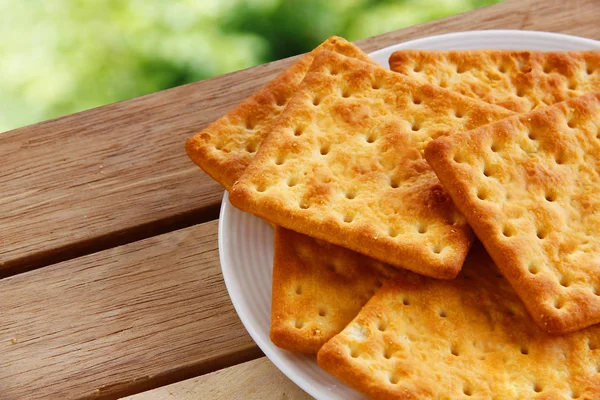 Salty Crackers are on wooden background. — Stock Photo, Image