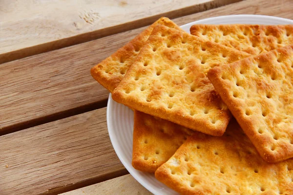 Salty Crackers are on wooden background. — Stock Photo, Image