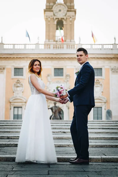 Novia y novio posan frente al Capitolio (Campidog — Foto de Stock