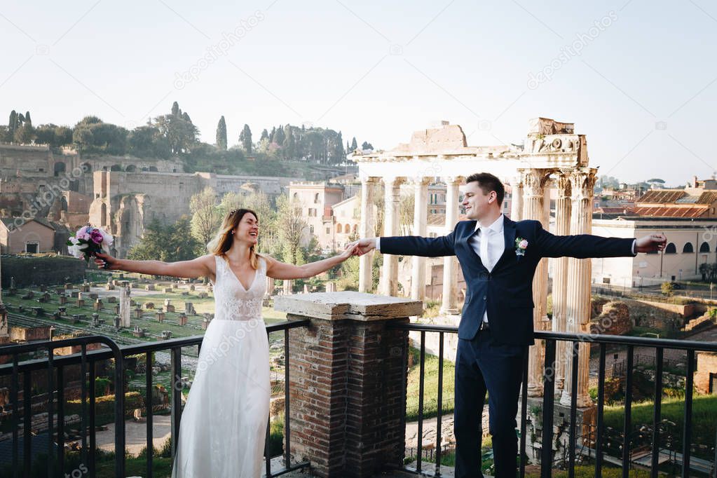 Bride and groom wedding poses in front of Roman Forum, Rome, Ita