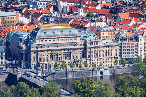 View of the Prague National Theater on a bright sunny day along the Vltava River, Czech Republic
