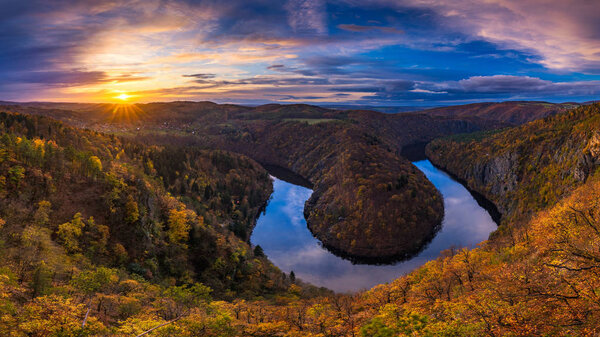 Panoramic view of river canyon with dark water and autumn colorf