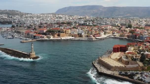 Aerial drone view video of iconic and picturesque Venetian old port of Chania with famous lighthouse and traditional character, Crete island, Greece. Architecture of the Venetian port in Chania. — Stock Video