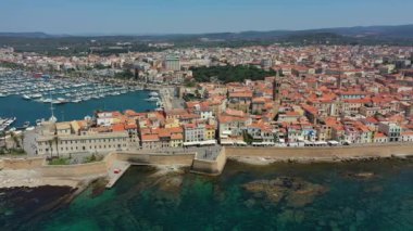 Alghero 'nun eski şehri üzerinde hava görüntüleri, güzel bir günde şehir manzarası, liman ve açık deniz manzaralı. Alghero, İtalya. Alghero, Sardinya, İtalya 'nın panoramik hava manzarası. 